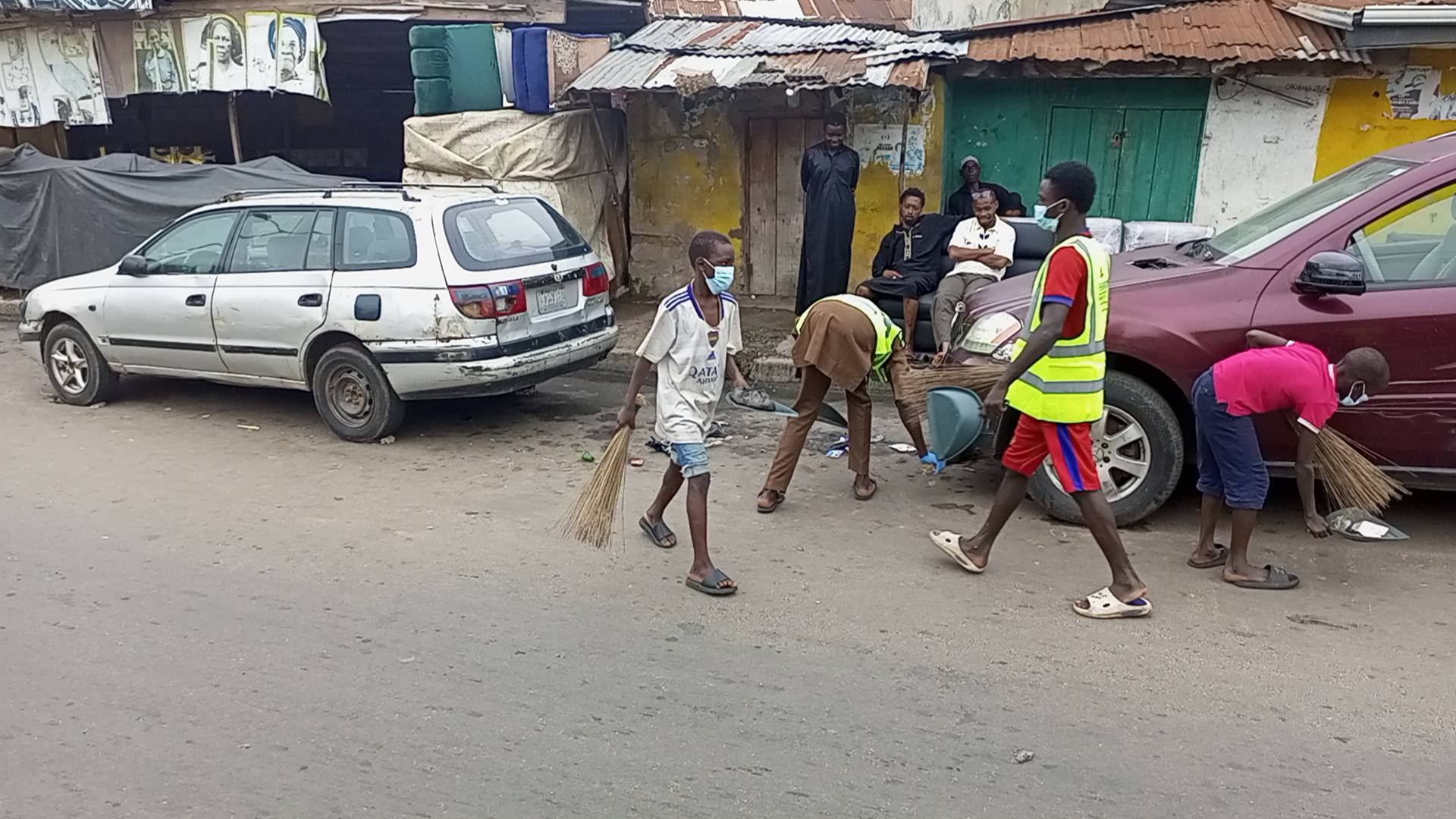 Young volunteers supporting neighbourhood cleanup.